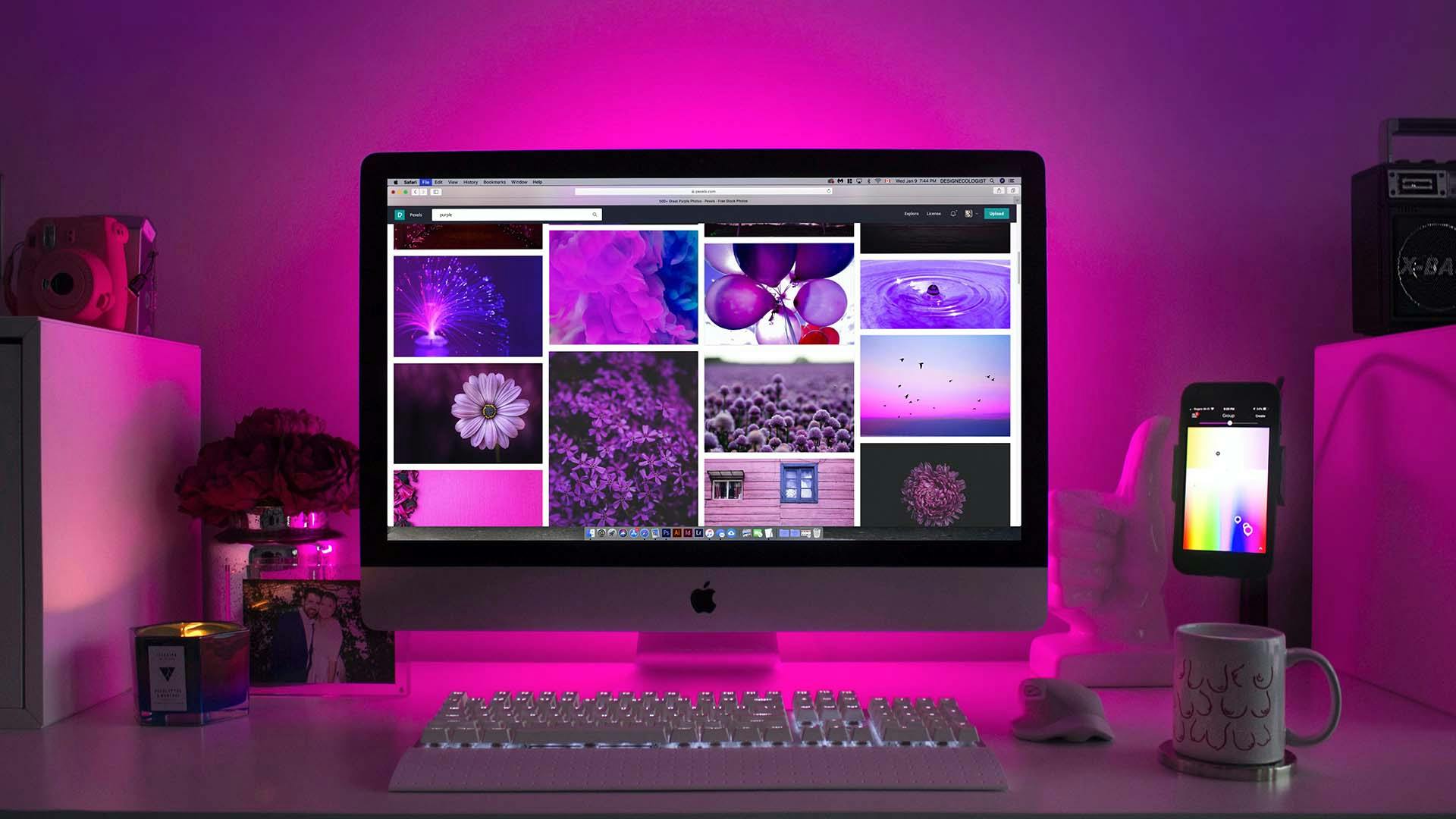 Silver iMac Displaying purple photos, and an iPhone displaying an RGB Color picker